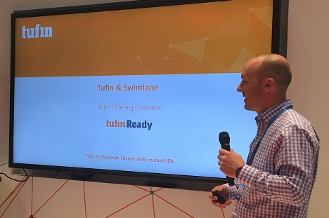Speaker presenting Tufin and Swimlane offering